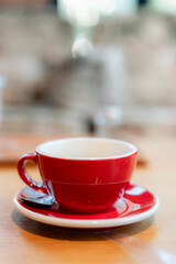Red coffee cup on a wooden table