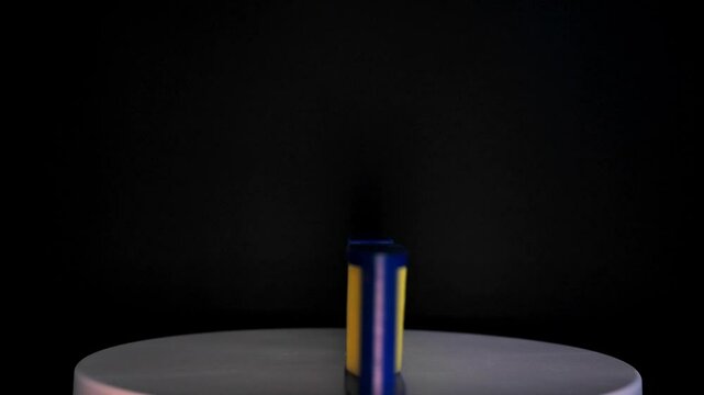 Footage of a spirit level  tool on a white plastic base rotating against a black background.