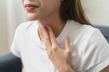 Close-up woman feel nausea touching her throat
