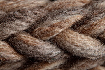Twisted strands of fiber form a dense, tactile surface ideal for handmade aesthetics, knitting content, or textile design themes with a natural, warm appeal.

