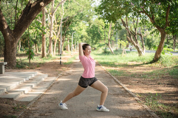 Asian women are stretching their muscles before going out to run to the park to keep themselves...