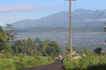 Urban natural scenery is visible from rural mountains, rice fields, trees.