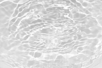 White water with ripples on the surface. Defocus blurred transparent white colored clear calm water surface texture with splashes and bubbles. Water waves with shining pattern texture background.
