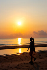 Fototapeta premium Sunrise and silhouette of traveler