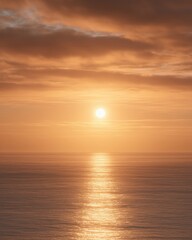 Golden Sunset Over Calm Ocean with Sun Reflection

