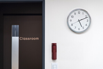 clock and door of the classroom in the cram school