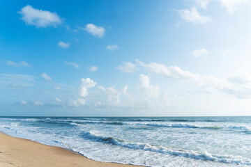 beautiful beach and tropical sea under the blue sky with white clouds