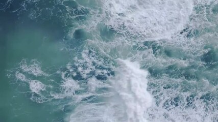 Experience the mesmerizing dance of pure blue ocean waves in slow motion, where light reflections shimmer across the surface, creating an ethereal glow. As the storm intensifies, powerful waves crash  - Powered by Adobe