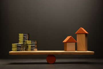 Real estate investment concept with money and houses balanced on a scale, representing value and financial planning