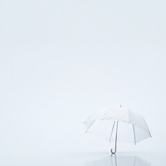 A small, clear umbrella sits on a minimalist, light-blue background, reflecting faintly