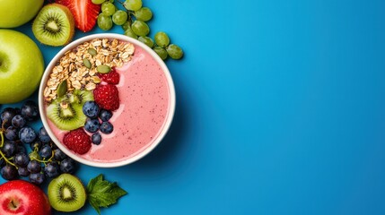 Colorful and refreshing smoothie bowl with fresh fruits and granola on blue background