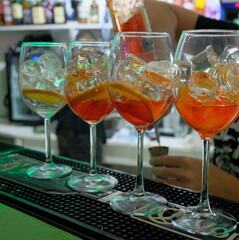 various glasses and dishes on the bar stock you can see hands human drinks beauty hand movements in the distance bottles name not visible rasofkus in the distance