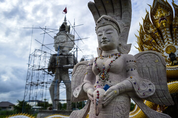 Thai Angel Statue and Statues of Serpent Guarding temples at Phra That Wisutthiyan Temple (Trailaksanaram Forest Temple) Doi saket, Chiang Mai, Northern Thailand