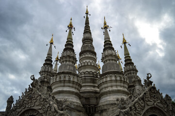 Fototapeta premium Pagoda in evening, Lanna Architecture, Symbols of Buddhism, South East Asia at Phra That Wisutthiyan Temple (Trailaksanaram Forest Temple) Doi saket, Chiang Mai, Northern Thailand
