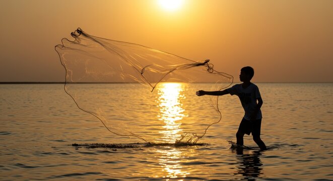 Boy casting a fishing net at sunset on a calm sea, with golden reflections and serene ambiance