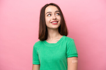 Obraz premium Young Ukrainian woman wearing a band aids looking up while smiling