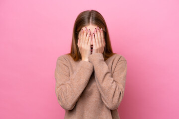 Teenager Russian girl isolated on pink background covering eyes by hands