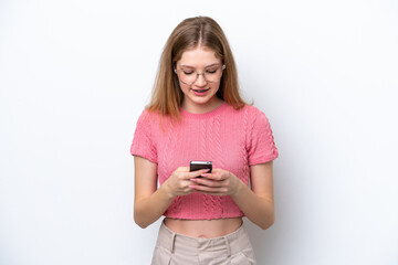 Fototapeta premium Teenager Russian girl isolated on white background sending a message with the mobile