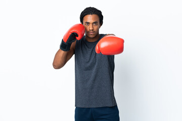 Young African American man with braids isolated on purple background with boxing gloves