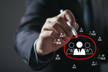 A hand is drawing a circle around figures, symbolizing focus on a target audience or team dynamics in a professional setting.
