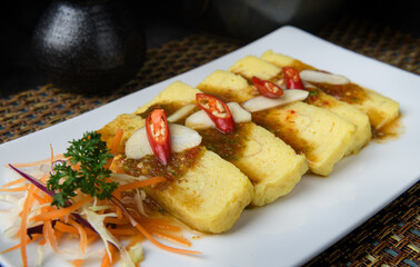 Japanese Tamago Yaki (Sweet Omelette) Topped with Spicy Sauce.