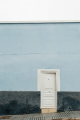 White Door on Minimal Light Blue Wall
