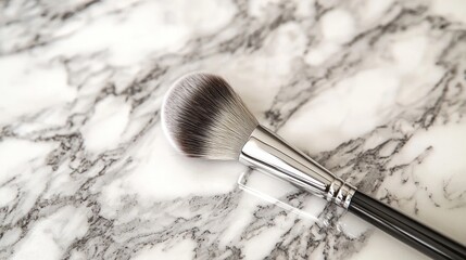A blending brush with soft, fluffy bristles on a marble countertop