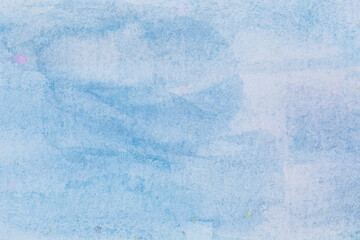 Macro close-up of hand painted light blue watercolor background with watercolour stains and brush strokes. High resolution full frame textured paper background with copy space.