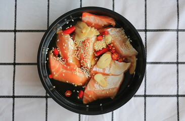 Pickled salmon Korean soy sauce marinated Korean food on table. Top view.