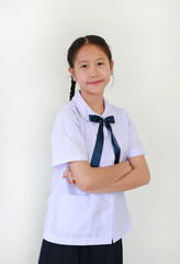 Portrait of smiling pretty Asian student girl in school uniform stand with arms crossed against white studio background.