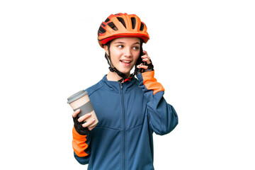 Teenager cyclist girl over isolated chroma key background holding coffee to take away and a mobile