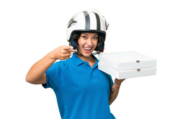 Pizza delivery Argentinian woman with work uniform picking up pizza boxes over isolated background...