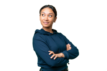 Young Uruguayan woman over isolated chroma key background with arms crossed and happy