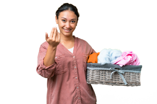 Young Uruguayan woman holding a clothes basket over isolated chroma key background inviting to come with hand. Happy that you came