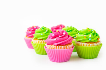 Colorful cupcakes with sprinkles displayed in brightly colored wrappers