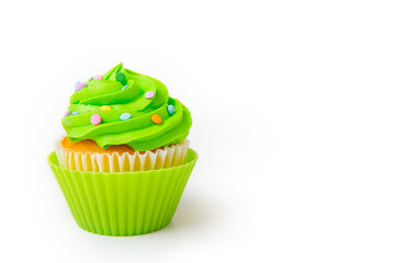 Delicious cupcake with bright green frosting and decorative sprinkles