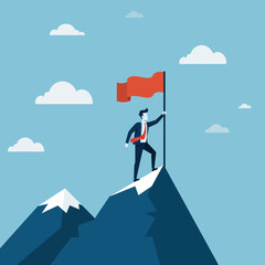 Businessman planting flag on mountain peak symbolizing success and achievement