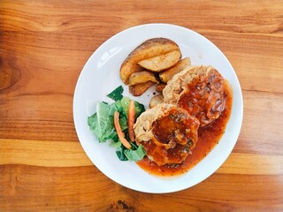 Double crispy tenderloin steak served with potato wedges, green vegetable and barbecue sauce