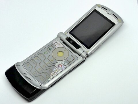 Motorola RAZR V3 opened and showing keyboard lying on white background