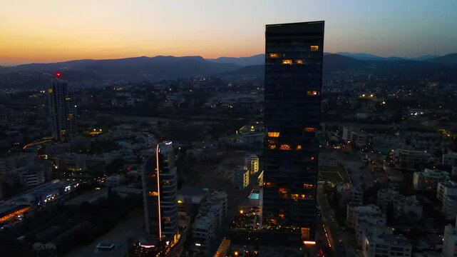 Limassol evening view of the city of Cyprus. Airy summer sunset and high-rise buildings on the embankment in the Mediterranean Sea.