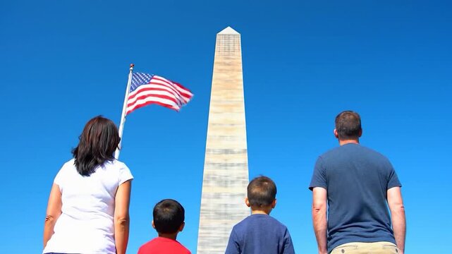 Family Gaze at Washington Monument with American Flag Waving on a Clear Day