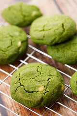 Chewy matcha chocolate chip cookies on cooling rack.