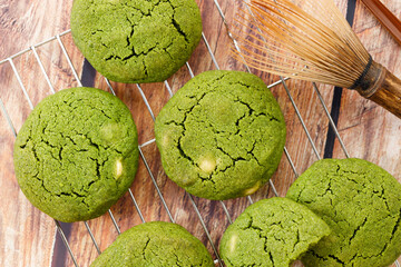 Chewy matcha chocolate chip cookies on cooling rack.