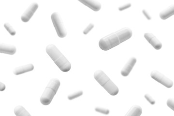 Falling white medicine pills capsule isolated on white background