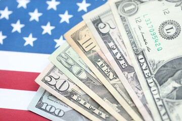 American US dollars money bills and on American flag close up