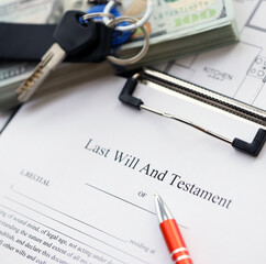 Pen and keys on Last will and testament form and planning blueprints of residential building project