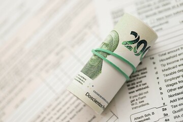 Mexican pesos money bills in big amount lies on table with tax forms close up