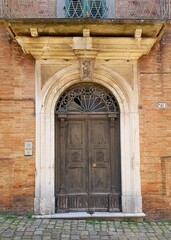 Old wooden door in the historic center of Bologna, Italy