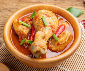 Chicken curry Asian food masala. Traditional cooking healthy food with spices. Arranged on wooden table background.