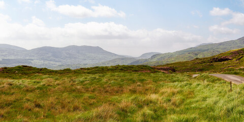 View of rural irish landscape, path through the gap of dunloe leading into the distance, county kerry.
